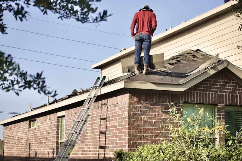 Professional roofer working on a residential roof in Bissell